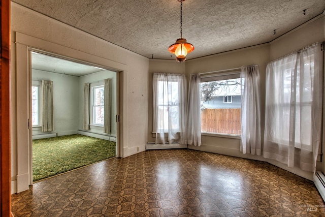 unfurnished dining area with a textured ceiling and baseboard heating