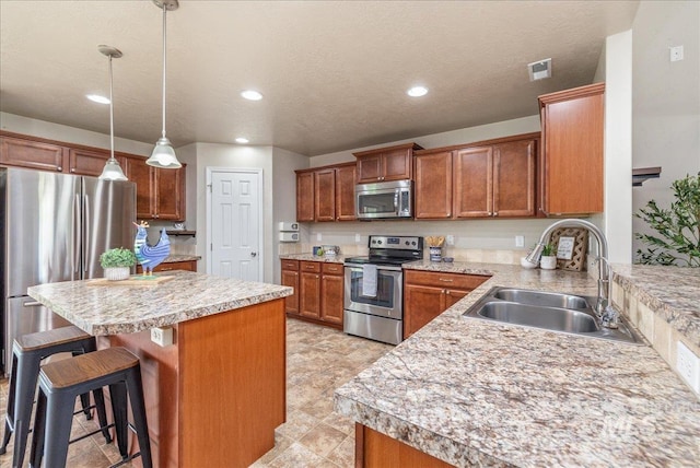 4665 N Beaham Ave, Meridian, ID 83646 - kitchen with appliances with stainless steel finishes, a sink, a breakfast bar, light countertops, and recessed lighting
