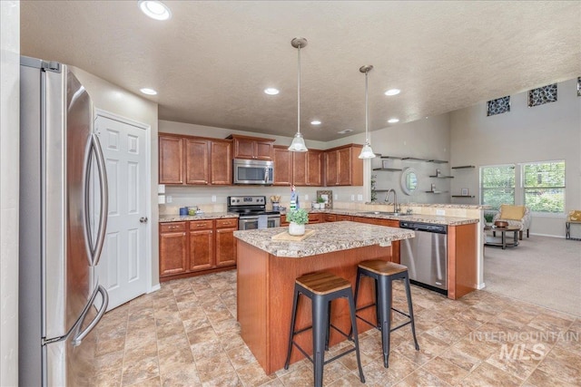 4665 N Beaham Ave, Meridian, ID 83646 - kitchen featuring stainless steel appliances, a sink, a peninsula, brown cabinets, and recessed lighting