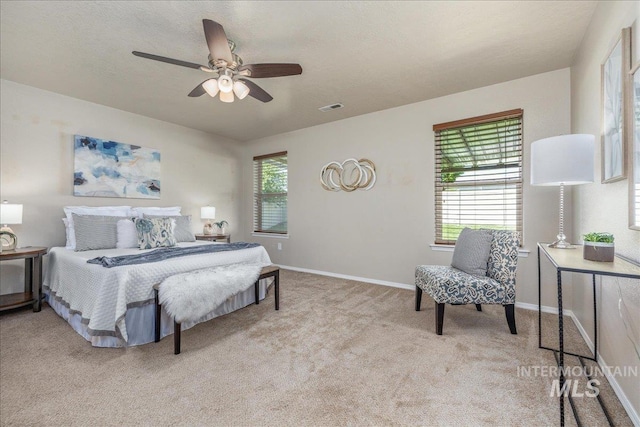 4665 N Beaham Ave, Meridian, ID 83646 - bedroom with multiple windows, light colored carpet, baseboards, and a ceiling fan