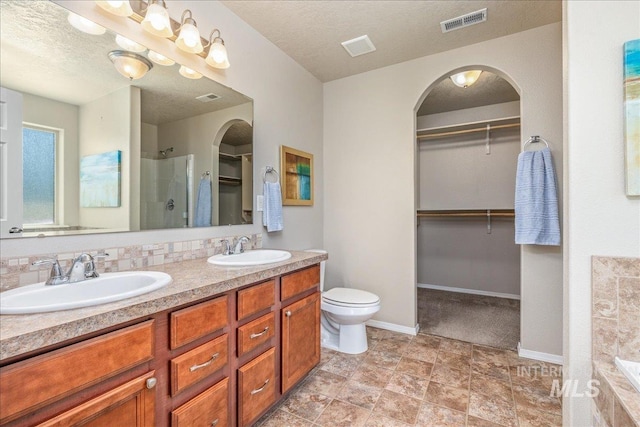 4665 N Beaham Ave, Meridian, ID 83646 - full bathroom featuring a spacious closet, double vanity, walk in shower, toilet, and baseboards