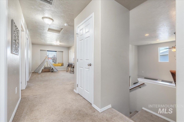 4665 N Beaham Ave, Meridian, ID 83646 - corridor featuring a textured ceiling, attic access, carpet flooring, an upstairs landing, and baseboards