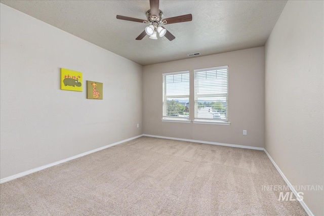 4665 N Beaham Ave, Meridian, ID 83646 - empty room with light carpet, ceiling fan, a textured ceiling, and baseboards