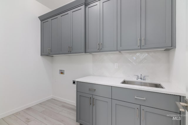 8601 W Pond Pine St, Star, ID 83669 - laundry area featuring electric dryer hookup, washer hookup, cabinet space, and light wood-style flooring