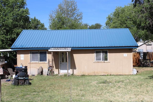 rear view of house with a yard