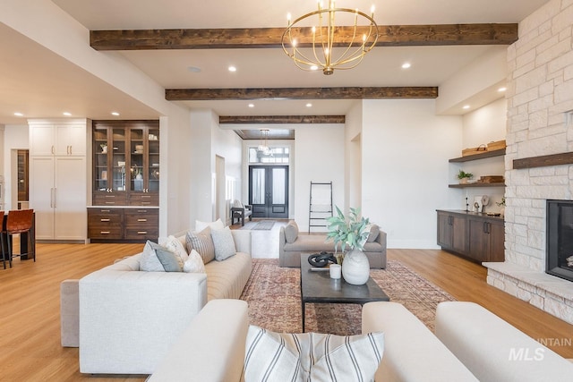 3426 N Hardwick Ave, Eagle, ID 83616 - living room with a chandelier, light wood-style floors, beam ceiling, recessed lighting, and a stone fireplace