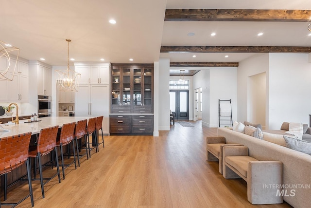 3426 N Hardwick Ave, Eagle, ID 83616 - living area featuring a chandelier, light wood-type flooring, beamed ceiling, and recessed lighting