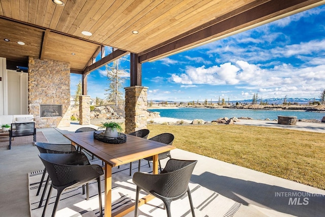 3426 N Hardwick Ave, Eagle, ID 83616 - view of patio with an outdoor stone fireplace, a water view, and outdoor dining area