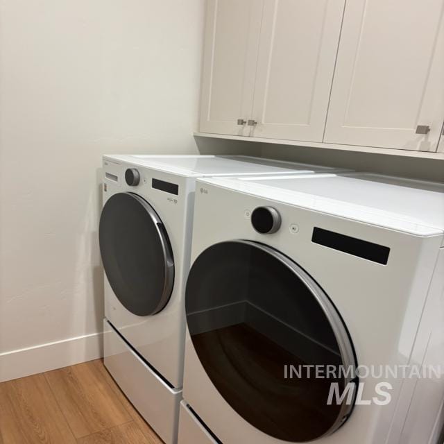 3426 N Hardwick Ave, Eagle, ID 83616 - laundry room with independent washer and dryer, cabinet space, and light wood finished floors