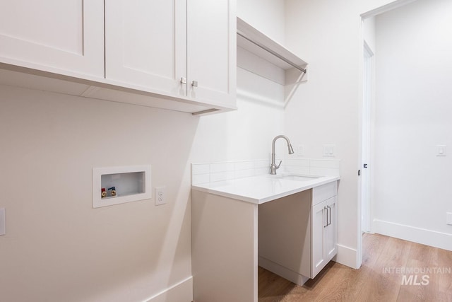 3426 N Hardwick Ave, Eagle, ID 83616 - washroom with washer hookup, cabinet space, and light wood-type flooring