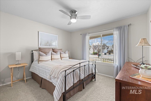 bedroom with baseboards, carpet, and a ceiling fan