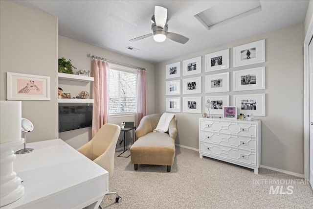 office space with carpet, baseboards, visible vents, attic access, and ceiling fan