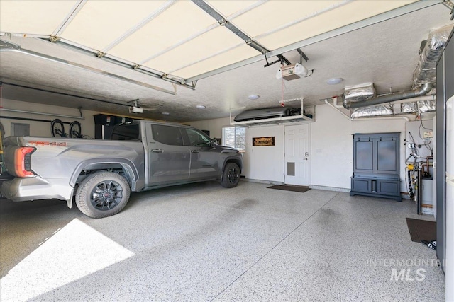 garage featuring a garage door opener and baseboards