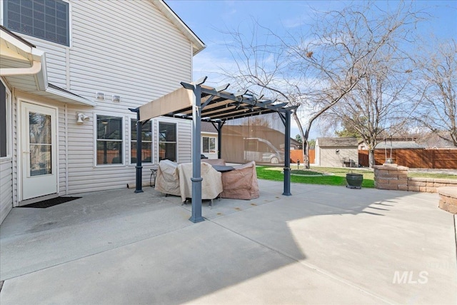 view of patio / terrace featuring an outdoor structure, fence, a pergola, and a shed