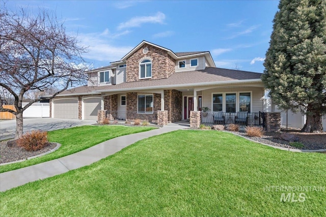 view of front of home featuring a front yard, fence, a porch, an attached garage, and concrete driveway