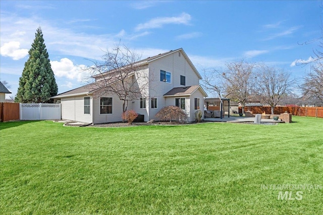 back of property featuring a yard, a fenced backyard, and a patio area