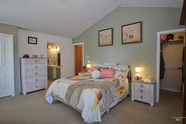 bedroom featuring lofted ceiling, a walk in closet, carpet, and a textured ceiling