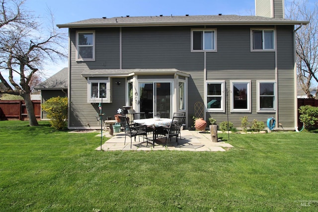 back of property with a patio, fence, a chimney, and a yard