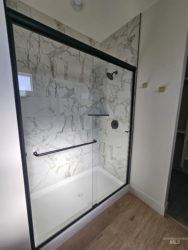 436 Autumn Blaze, New Plymouth, ID 83655 - bathroom with baseboards, wood finished floors, and a stall shower