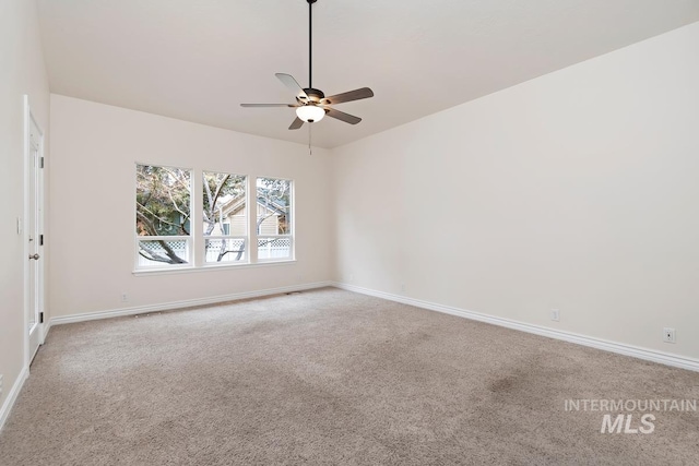 unfurnished room featuring carpet, a ceiling fan, and baseboards