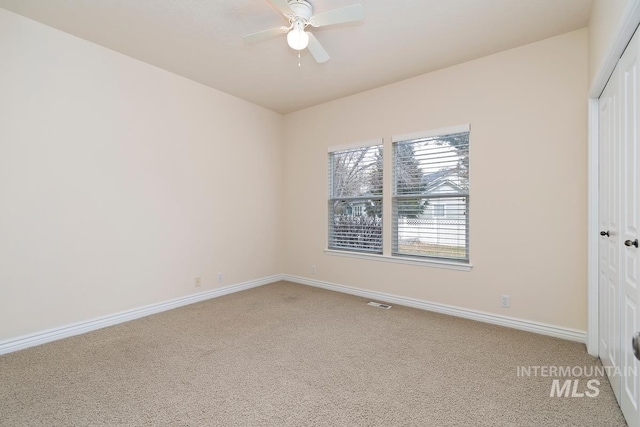 unfurnished bedroom with baseboards, a closet, visible vents, and light colored carpet