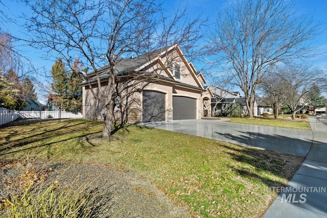 view of home's exterior featuring driveway, a garage, a lawn, fence, and stucco siding