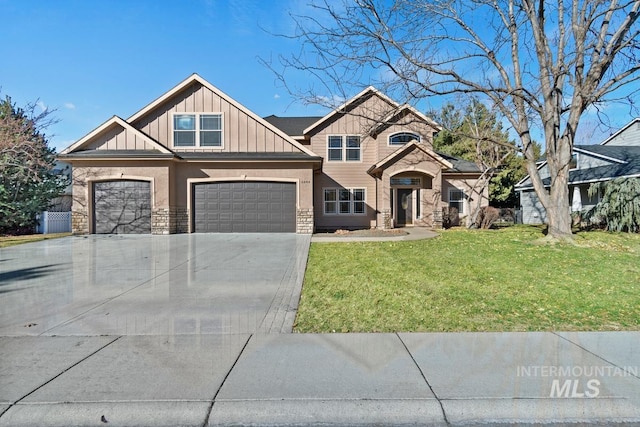 craftsman house featuring an attached garage, board and batten siding, a front yard, stone siding, and driveway