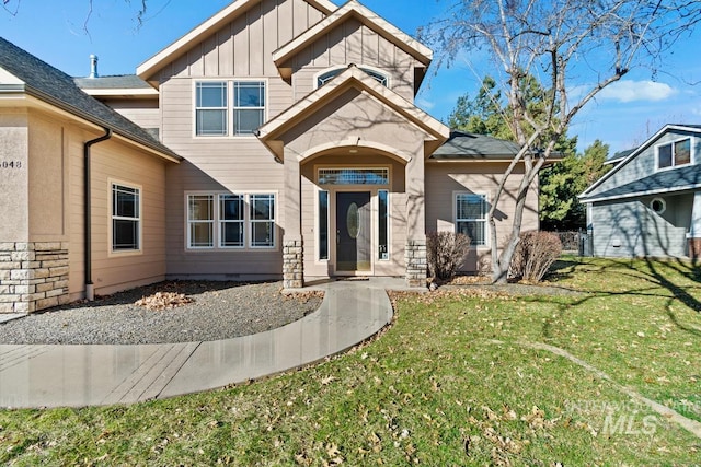 view of front of house with a front lawn and board and batten siding