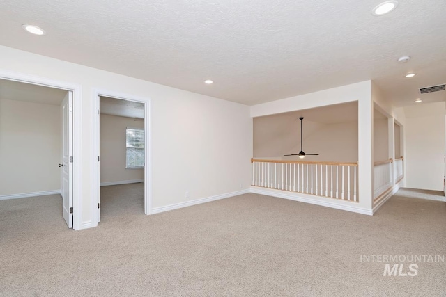 spare room featuring recessed lighting, visible vents, and baseboards