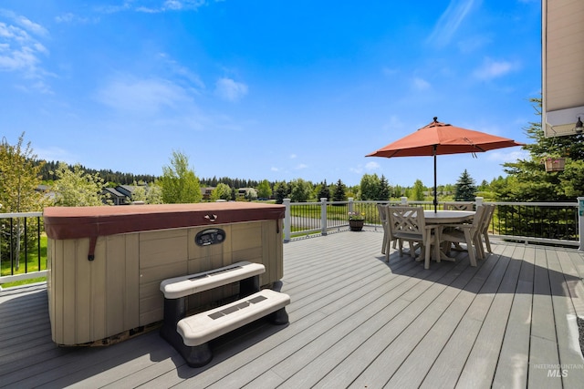 1017 Potts Dr, Mccall, ID 83638 - deck featuring a hot tub, outdoor dining space, and view of wooded area