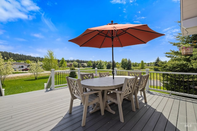 1017 Potts Dr, Mccall, ID 83638 - wooden terrace featuring outdoor dining area, a yard, and view of wooded area