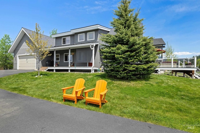 1017 Potts Dr, Mccall, ID 83638 - traditional-style home with covered porch, driveway, a garage, and a front lawn