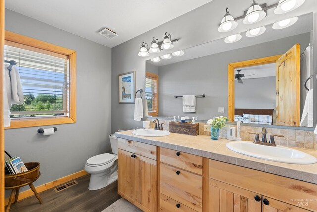 1017 Potts Dr, Mccall, ID 83638 - bathroom featuring wood finished floors, double vanity, healthy amount of natural light, and ceiling fan