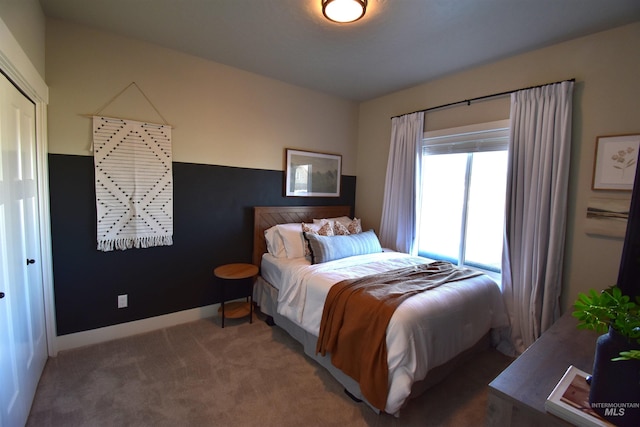 bedroom with carpet floors and baseboards