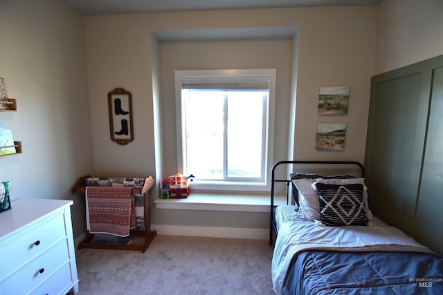 bedroom featuring carpet flooring and baseboards