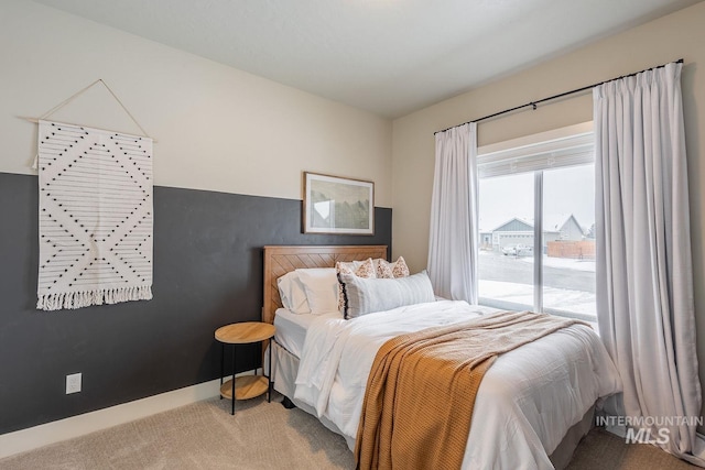 bedroom featuring carpet flooring and baseboards