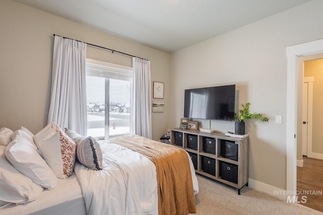 bedroom with carpet floors and baseboards