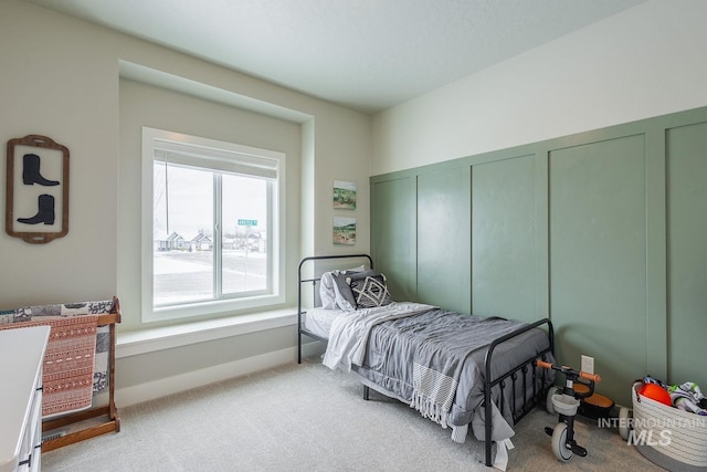 bedroom with carpet floors and baseboards