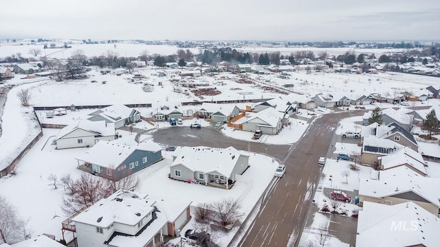 snowy aerial view featuring a residential view