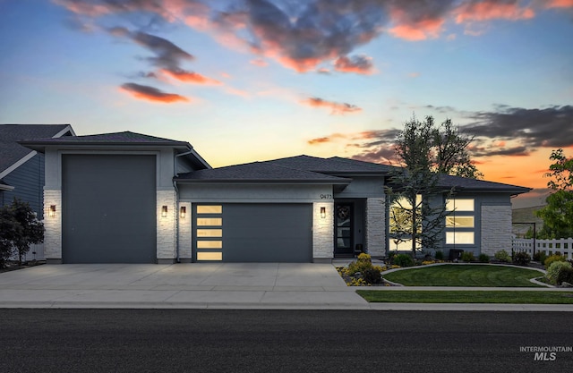 9473 W Suttle Lake Dr, Boise, ID 83714 - view of front facade featuring a garage, stone siding, and driveway