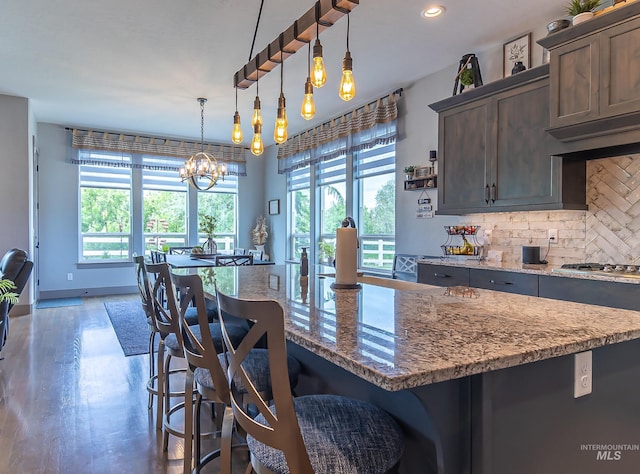 9473 W Suttle Lake Dr, Boise, ID 83714 - kitchen featuring plenty of natural light, tasteful backsplash, stainless steel gas stovetop, dark brown cabinetry, and recessed lighting