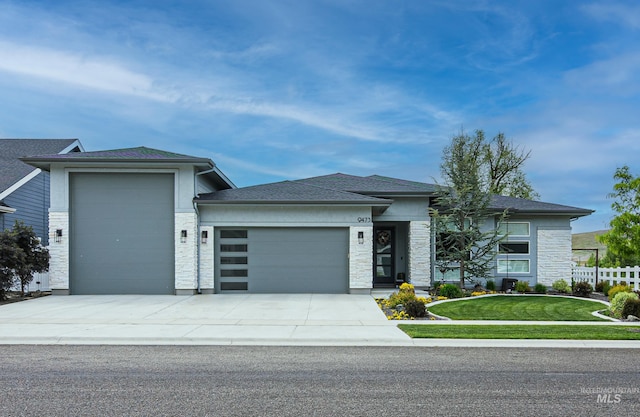 9473 W Suttle Lake Dr, Boise, ID 83714 - prairie-style house featuring an attached garage, stone siding, and driveway