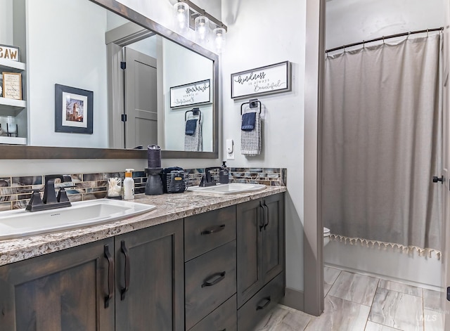 9473 W Suttle Lake Dr, Boise, ID 83714 - bathroom with double vanity, decorative backsplash, and toilet