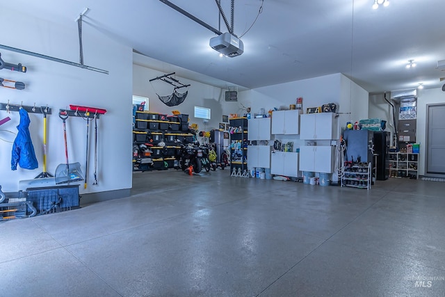 9473 W Suttle Lake Dr, Boise, ID 83714 - garage featuring a garage door opener and a workshop area