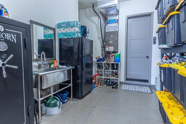 9473 W Suttle Lake Dr, Boise, ID 83714 - garage featuring freestanding refrigerator, heating unit, and a sink