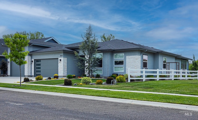9473 W Suttle Lake Dr, Boise, ID 83714 - prairie-style home with an attached garage, stone siding, concrete driveway, and roof with shingles