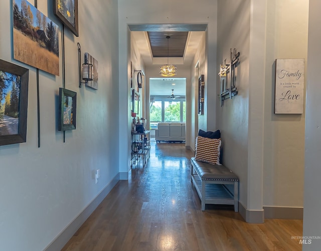 9473 W Suttle Lake Dr, Boise, ID 83714 - hallway featuring baseboards, a tray ceiling, and wood finished floors