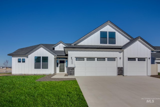 8196 E Red Horse St, Nampa, ID 83687 - modern farmhouse style home featuring concrete driveway, a front lawn, a garage, and board and batten siding