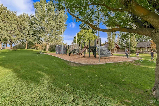 view of jungle gym featuring a lawn