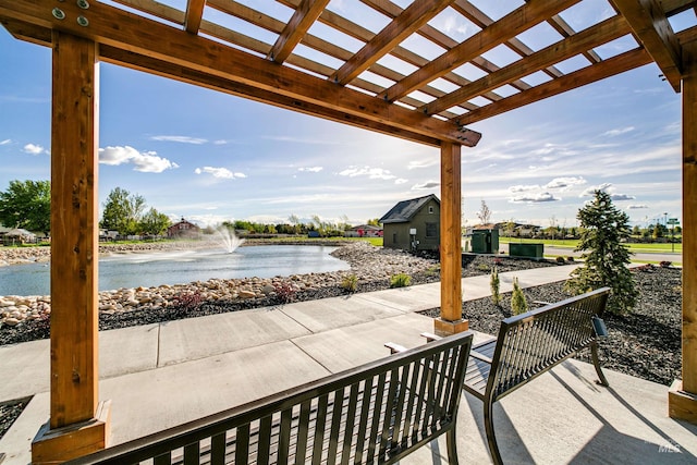 view of patio featuring a water view and a pergola